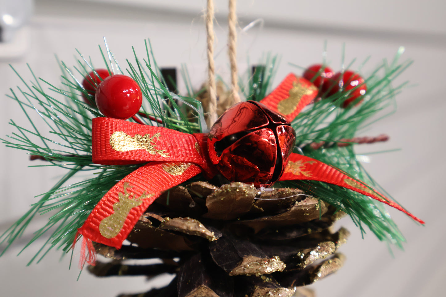 AG-37 | Artificial Pinecone Christmas Hanging Ornament with Red Ribbon & Bell – 3.5" × 3" (9 × 8 cm)