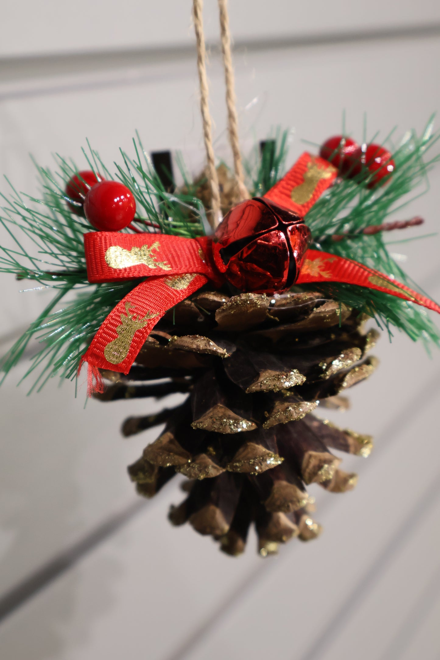 AG-37 | Artificial Pinecone Christmas Hanging Ornament with Red Ribbon & Bell – 3.5" × 3" (9 × 8 cm)
